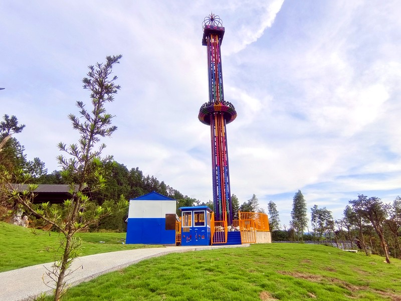 Visitors watching a drop tower ride prepare for a cycle