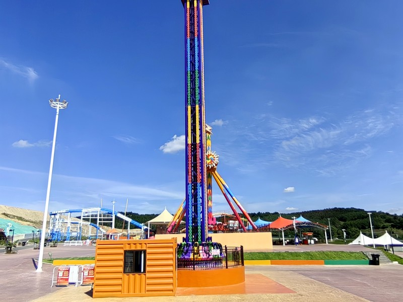 Close view of a drop tower ride carriage and guest seating